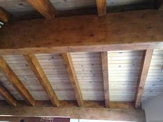 the inside of a building with wooden beams and wood flooring on the ceiling,