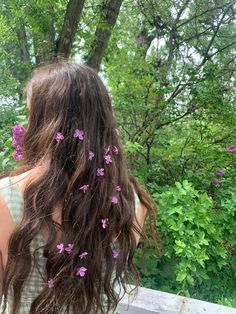 the back of a woman's head with flowers in her hair