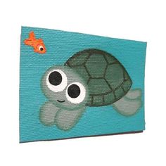 a painting of a turtle and a goldfish on a blue background with white border