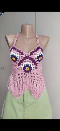 Get ready for summer festivals with our handcrafted crochet granny square halter top. Made from vegan-friendly materials, this boho top is perfect for any free spirit. *🌸 Handcrafted with love and care *🧶 Vegan-friendly, cruelty-free materials *🎨 Unique granny square design *👗 Perfect for summer festivals and beach outings *🎁 Great as a birthday gift for friends and loved ones *🌿 Comfortable, breathable, and stylish *✨ Easy to pair with jeans, skirts, or shorts for a boho chic look Bohemian Granny Square Crochet Top For Beach, Summer Handmade Crochet Top, Handmade Bohemian Crochet Top For The Beach, Handmade Yarn Crochet Top For Beach, Bohemian Hand Knitted Crochet Top For Vacation, Handmade Yarn Crochet Top For Summer, Bohemian Hand-knitted Crochet Top, Bohemian Multicolor Summer Patterns, Festival Crochet Halter Neck Top