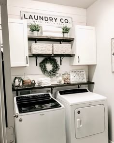 a white washer and dryer sitting in a laundry room next to each other