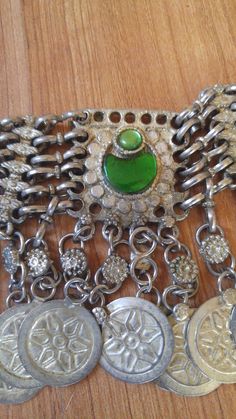 "80's silver tone Afghan Kuchi faux coin choker. There are green glass beads in the centre piece and at the ends, chain clasp at the back. Length in total 23\", at shortest 17 1/2\", width 1 1/2\"" Vintage Metal Necklace With Coin Pendant, Vintage Metal Medallion Necklace With Coin Pendant, Vintage Nickel Free Choker Necklace, Nickel-free Vintage Choker Necklace, Vintage Nickel-free Choker Necklace, Vintage Silver Chain Necklace For Festivals, Vintage Coin Shaped Medallion Necklace, Green Metal Necklaces For Festivals, Green Metal Necklace For Festival