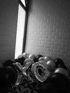 black and white photograph of balloons in front of a window with the number forty on it