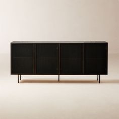 a black cabinet with three doors and two legs