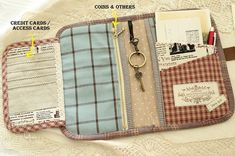 an open wallet with some papers and a key in it on a lace doily