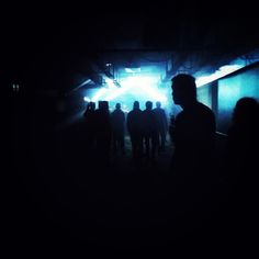 a group of people standing around in the dark