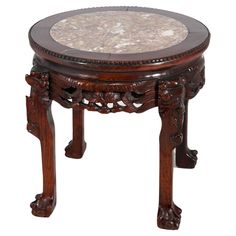 an ornate wooden table with marble top