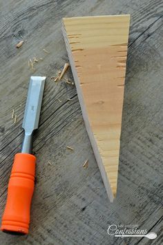 a piece of wood with a knife next to it