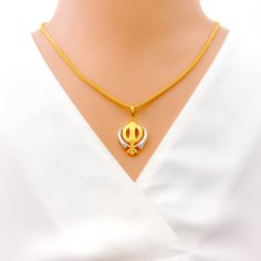 This tasteful Khanda pendant, made from 22k gold and weighing 3.8 grams, showcases an elegant dual-tone design with a primary yellow gold finish. Measuring 1.25 inches in length, it represents a blend of spiritual significance and contemporary style, embodying the essence of Sikh courage and remembrance. Ideal for those who appreciate symbolic jewelry with modern aesthetics, this dual-tone Khanda pendant is a meaningful addition to any collection, offering a touch of grace and tradition. PRODUCT DETAILS Gold Purity(karat): 22k Gold Weight(grams): 3.8 Item Finish: Yellow Gold Pendant Length: 1.25" Chain: Not Included Bridal Jewelry Necklace, Precious Stones Rings, Diamond Pendant Sets, Modern Bracelets, Fancy Necklace, Fancy Rings, Mens Gold Rings, Diamond Necklace Set, Traditional Earrings