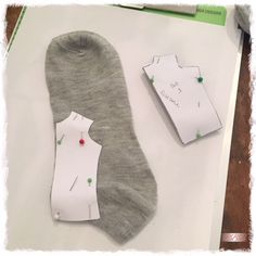 two pairs of socks are laying next to each other on a piece of white paper