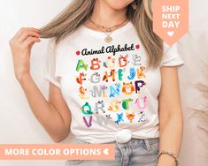 "This Alphabet Animal ABC Shirt for Back to School Teacher and Daycare Teacher Teams is a cute, soft tee for your favorite Kindergarten Teacher or grade school teacher teams for teacher appreciation or first day of school. HOW TO ORDER YOUR SHIRT 1) Select Your T-Shirt Size and Color from the drop down menus. 2) Choose Your Quantity. Feel free to add as much as you want. 3) Click ADD TO CART. You Can then go back add more sizes and colors for family members or friends. 4) Click \"Proceed to Chec Cute Multicolor Shirt With Custom Print, Cute Multicolor Tops With Funny Text, Cute Multicolor Tops With Custom Print, Cute Multicolor Shirt With Letter Print, Cute Multicolor Crew Neck Shirt, White Novelty Tops As Gift, White Novelty Tops For Gifts, White Novelty Tops As A Gift, Playful White T-shirt With Funny Text