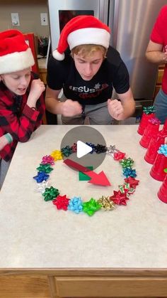 two boys are making christmas decorations on the kitchen counter while another boy is looking at them