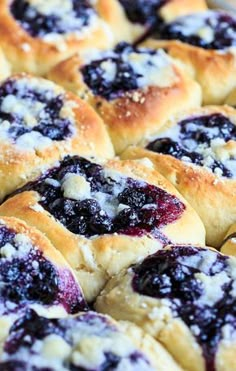 blueberry danish rolls with powdered sugar on top in a baking dish, ready to be eaten