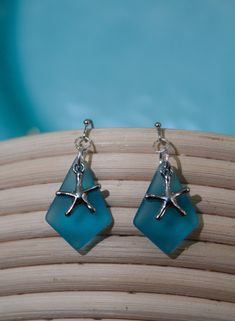 - Coastal Sea Glass Earrings - If you're looking for a beachy pair of earrings, you've just hit the jackpot! Frosted glass and cute coastal charms make these earrings perfect for wearing on that vacation you've been dreaming of...or maybe just to make you feel like you're on vacation :) If you have any questions, message me! Be sure to check out my Instagram page: @thecreativeoutlet19 Summer Starfish Charm Dangle Earrings, Summer Dangle Earrings With Starfish Charm, Nickel-free Dangle Earrings For Vacation, Nickel Free Dangle Earrings For Vacation, Nickel-free Drop Earrings For Vacation, Summer Starfish Charm Drop Earrings, Beach Earrings With Sea Glass And Ear Wire, Beach Sea Glass Earrings With Ear Wire, Summer Beach Earrings With Starfish Charm