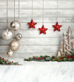 an image of christmas decorations hanging on the wall with stars and ornaments in front of it