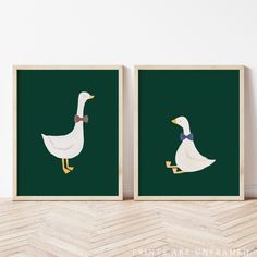 two white ducks with blue bows on their heads are standing in front of a green background