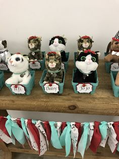 a group of stuffed animals sitting on top of a wooden table next to each other