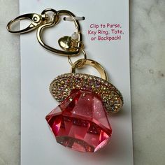 a keychain with a red jewel on it