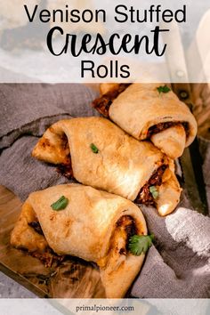 three venison stuffed crescent rolls on a cutting board with text overlay that reads, how to make venison stuffed crescent rolls