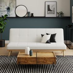 a living room with a white couch and wooden coffee table in front of a green wall