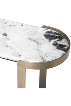 a white marble table with gold legs and an oval metal frame on the top, in front of a white background