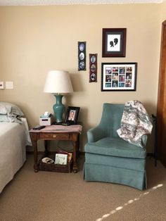 a bedroom with a bed, chair and pictures on the wall