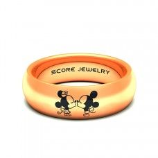 an orange ring with mickey and minnie mouses on the inside is engraved in gold