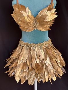 a mannequin with gold feathers on it