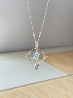 It's a handmade crystal orb necklace that are inspired by a picture of Saturn. We picked the the natural gemstone and wire wrapped the stone to create this planet with ring. The tranquil blue planet was made from Aquamarine, representing the fearless spirit of the sky and the sea. The white Herkimer Diamond at the bottom forms as a teardrop of the galaxy. It's a perfect gift for yourself, friends, and families who are fascinated by the mysterious galaxy and enjoy serenity. ･ﾟ✧Measurement (Heigh* Pendant Wrapping Wire Jewelry, Aquamarine Jewelry Necklace, Universe Necklace, Elven Necklace, Nebula Necklace, Orb Necklace, Planet Ring, Tranquil Blue, Crystal Orb