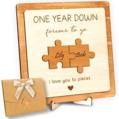 a wooden puzzle with the words, one year down and two pieces missing from it