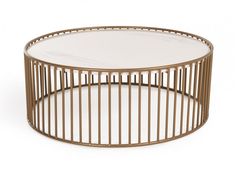 a round coffee table with metal bars on the bottom and glass top in gold tone