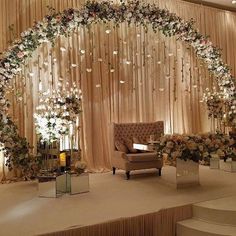 a stage decorated with flowers and greenery for a wedding or special event video call