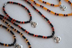 These fun and unique necklace and bracelet sets make a great addition to any Halloween costume. They are very nice and well made so you can wear them out or to the office to show that you are in the Halloween spirit and they will last for years. These jewelry sets also make a wonderful gift or party favor for your Halloween guests. The necklaces and bracelets are made with stretchy beading cord so this allows some flexibility in fit. I can make them to your desired length and also add a chain ex Fall Bead Necklaces, Halloween Beaded Necklace, Edgy Handmade Necklace For Halloween, Halloween Necklace Beads, Handmade Halloween Necklace, Adjustable Beaded Necklace For Halloween, Fall Bead, Bracelet Sets, Beading Cord