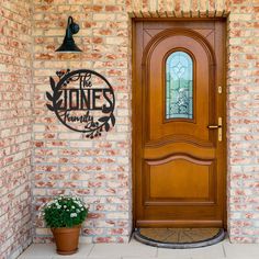 a wooden door sitting next to a potted plant