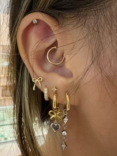 a close up of a person's ear with two different types of earrings on it