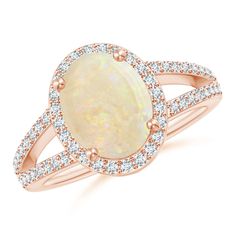 Captivating with a fascinating color play is the oval GIA certified opal secured in a prong setting. It is encircled by a glimmering halo of diamonds, enhancing the luxurious look of this vintage inspired ring. Also, the diamond accents on the split shank and the detailing on the gallery infuse a hint of opulence to this striking 18k rose gold oval opal ring. Oval Opal Ring, Vintage Inspired Rings, Cartier Panthere, Bracelet Love, Color Play, Gio Ponti, Split Shank, Opal Ring, Halo Ring