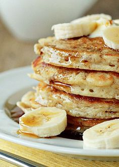 pancakes with bananas and syrup on a plate