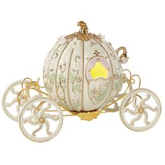 a fancy white and gold carriage with wheels