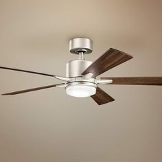 a ceiling fan with two wooden blades and a light on the top one is turned on