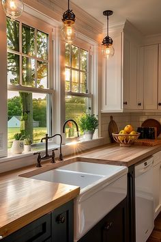 a kitchen filled with lots of counter top space next to a sink and window covered in hanging lights