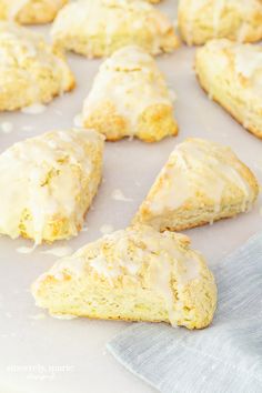 glazed scones are sitting on a baking sheet