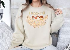 Embrace the fall vibes with our Fun Happy Fall Mushrooms Sweatshirt! Perfect for turning heads at gatherings or giving as a unique gift to someone special. Whether you're enjoying cozy fall days or celebrating the season, this sweatshirt adds the perfect touch of fun to your closet! The Gildan is a classic unisex crewneck sweatshirt made from a soft and durable cotton-polyester blend. Featuring a comfortable fit, it offers warmth and versatility for everyday wear. Ideal for casual outfits or layering, the Gildan is a go-to for style and comfort. Please refer to the size chart in the images for the best fit. FABRIC DETAILS: Solid colors: medium-heavy fabric blend of 50% polyester, 50% cotton. Heather colors: 60% Polyester, 40% cotton. Unisex sizing for sweatshirts. Each item is individually Fall Mushrooms, Thankful Shirt, Fall Days, Fall Tee, Fall Shirt, Trendy Fall, Trendy Shirts, Fabric Details, Happy Fall