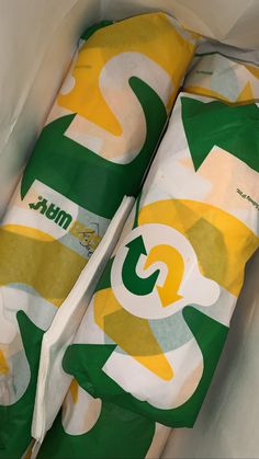 two rolls of green and yellow wrapping paper