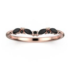 a rose gold ring with black stones