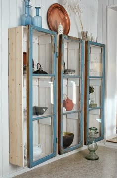 an old bookcase is being used as a display case for other items in the room