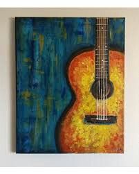 a painting of an acoustic guitar hanging on the wall