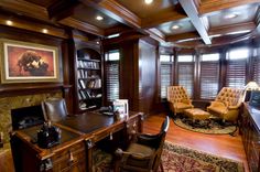 a home office with wood paneling and leather chairs