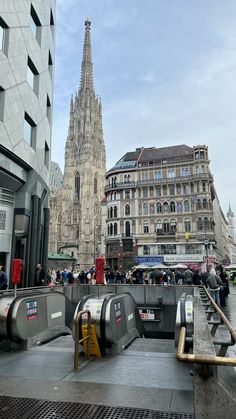 people are walking around in front of a tall building