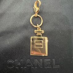 Authentic Chanel Perfume Keycharm From The Beauty Collection - New Double Sided With Chanel Stamped On Both Sides. Perfect For Keys Or To Add To A Bag. Will Include The Lariat Necklace With Purchase In Second Pic Also Adorable To Upcycle Into Jewelry For An Affordable Chanel Necklace, Chanel Earrings, Chanel Choker, Chanel Bracelet, Etc (See Examples! Not Included In Purchase Of Keycharm But Are For Sale On Our Site) Chanel Keychain Chanel Charm Elegant Bag Charm With Logo, Luxury Logo Bag Charm For Gift, Luxury Logo Bag Charm As Gift, Elegant Gold Bag Charm For Gift, Gold Logo Charm Bag Charm, Elegant Gold Bag Charm As Gift, Luxury Gold Bag Charm As Gift, Luxury Removable Charms For Gifts, Elegant Bag Charm With Charms As Gift