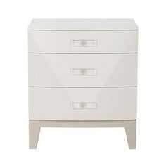 a white dresser with three drawers on it